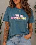 He Is Working – Romans 8:28 Christian Tee