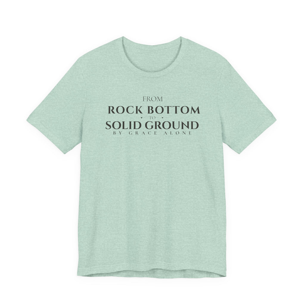 From Rock Bottom to Solid Ground Tee – By Grace Alone Christian Shirt